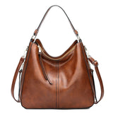https://cdn.shopify.com/s/files/1/1057/5383/7908/files/Justine____Timeless_Leather_Bag_1.jpg?v=1785187531