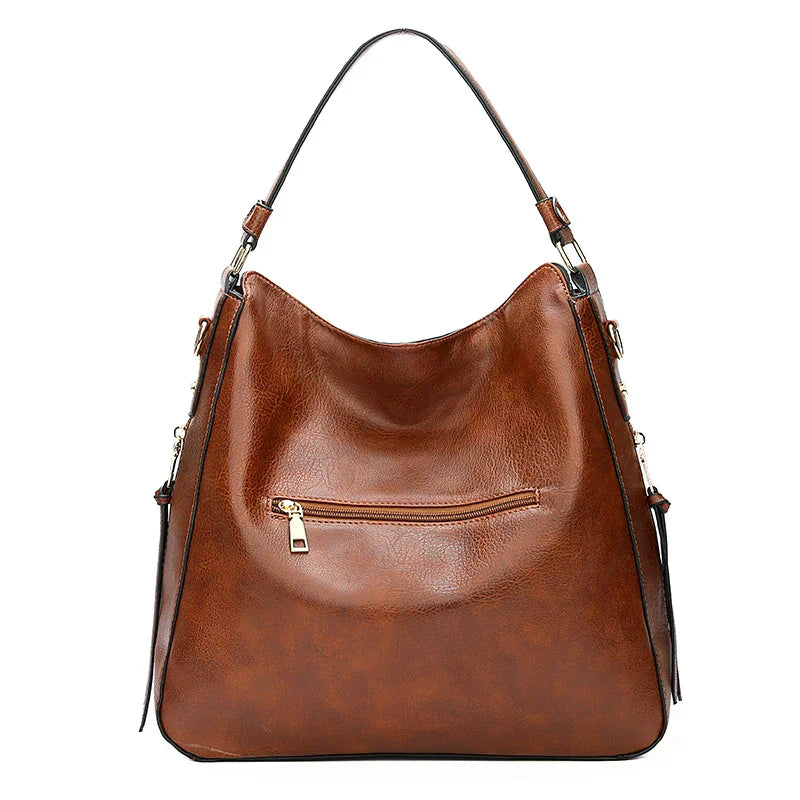 https://cdn.shopify.com/s/files/1/1057/5383/7908/files/Justine____Timeless_Leather_Bag_5.jpg?v=1785187531