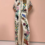 https://cdn.shopify.com/s/files/1/1037/6196/9489/files/Modern-Sophisticated-Feel-Satin-Unique-Print-Button-Down-Oversized-Blouse.jpg?v=1780780329