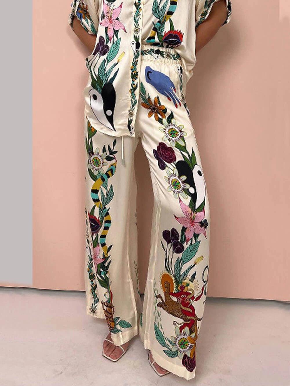 https://cdn.shopify.com/s/files/1/1037/6196/9489/files/Satin-Unique-Print-Elastic-Waist-Pocketed-Wide-Leg-Pants.jpg?v=1780780329