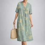 https://cdn.shopify.com/s/files/1/1037/6196/9489/files/polish-model-posed-studio-shot-sage-green-floral-linen-midi-dress-full-body.png?v=1783845542