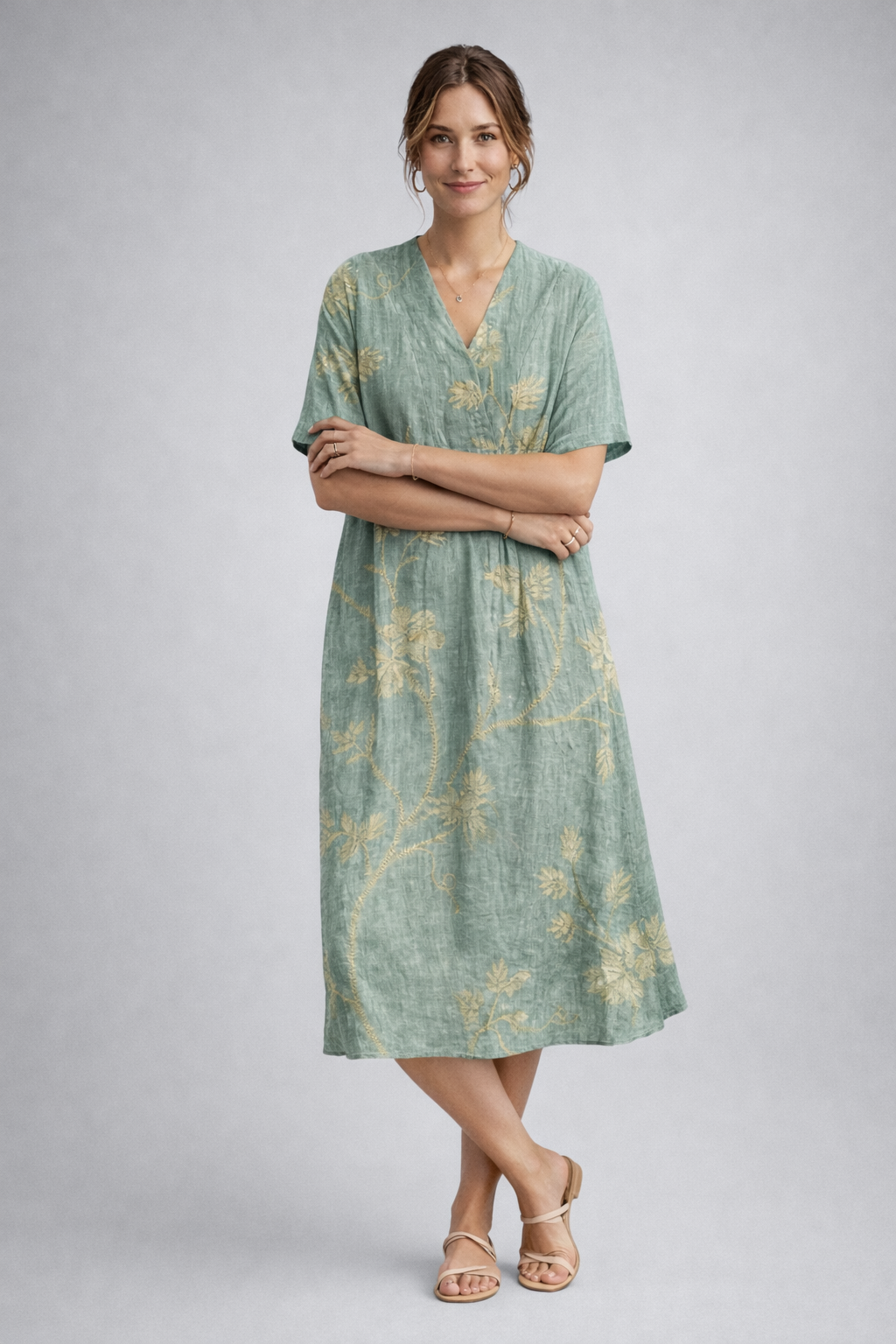 https://cdn.shopify.com/s/files/1/1037/6196/9489/files/sage-green-floral-linen-midi-dress-posed-model-studio-shot-full-body.png?v=1783845542