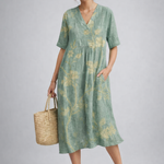 https://cdn.shopify.com/s/files/1/1037/6196/9489/files/sage-green-floral-midi-dress-model-posed-studio-sh.png?v=1783845542