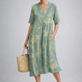 https://cdn.shopify.com/s/files/1/1037/6196/9489/files/sage-green-floral-midi-dress-model-posed-studio-sh.png?v=1783845542